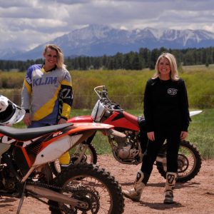 Girls with dirtbikes in front of Pikes Peak
