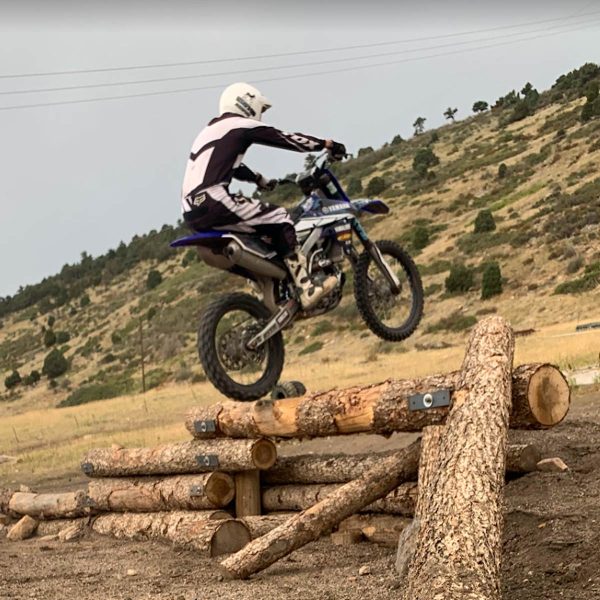 Dirtbike instructor Keith Wineland demonstrates how to go up logs