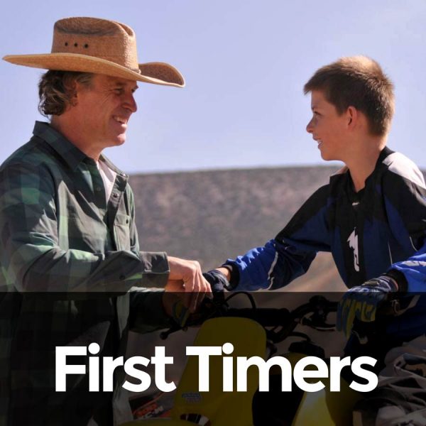 Photo of dirtbike instructor teaching kids to ride for the first time